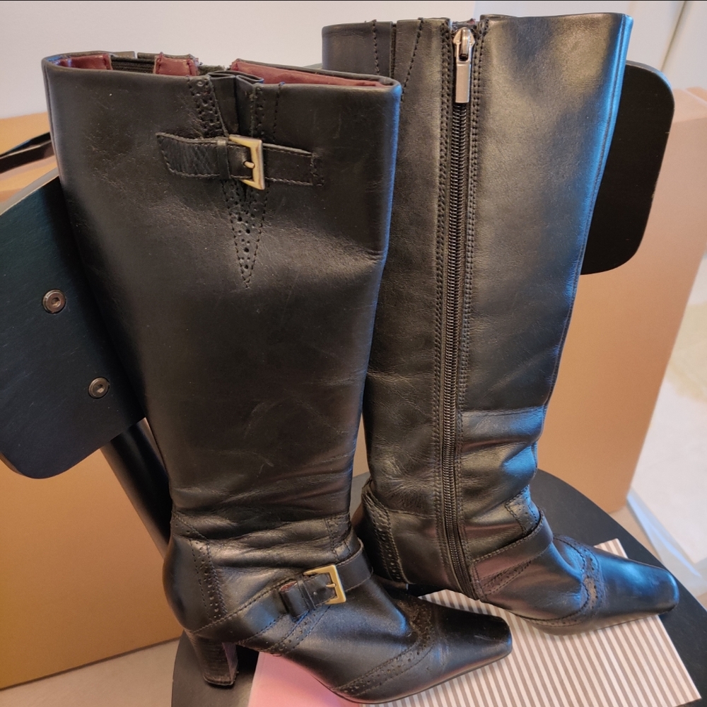 Leather knee high boots with wing tip detailing